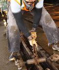 Worker using Flame And Arc Resistant Leather Driver Gloves With Durahide Leather, Water Repellent Finish, in industrial setting.