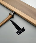 8 Pack Black T Shape Gate Hinges With Screws Zinc Plated T Strap Hinges next to wooden handle and board