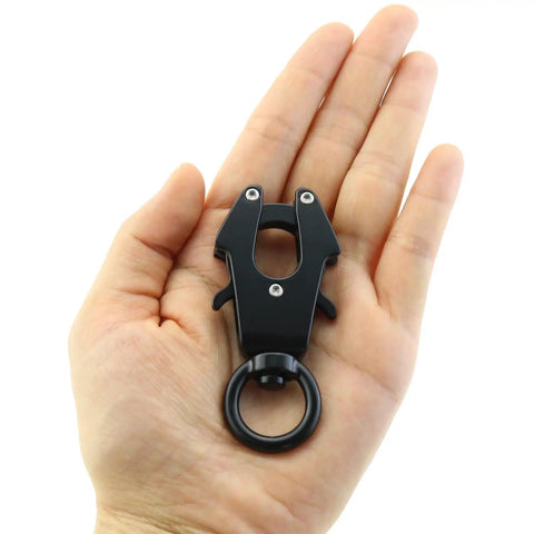 Hand holding a Beefy Heavy Duty Aluminum Alloy Carabiner With 360 Degree Rotation Quick Release Frog Buckle Clip For Camping And Hiking