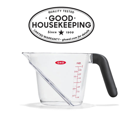 Angled 2 Cup Measuring Cup With Easy Read From Above Measurements, BPA Free Tritan Renew, with non-slip handle, shown side view.