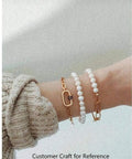 Person wearing pearl bracelets with Mixed Color Micro Pave Cubic Zirconia Carabiner Lock Charms, Oval Clasp, on wrist.