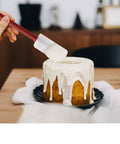 Using 3 Pack Heat Resistant Silicone Spatulas 9.5 Inch Nonstick Safe BPA Free Pro Grade to frost a cake with icing.
