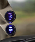 Two GlowShift 2-1/16 in digital oil pressure gauges with blue LED displays installed on car A-pillar.