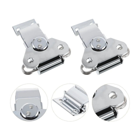 Close-up of spring-loaded stainless steel butterfly latches with silver finish for wooden boxes, part of a three piece set.