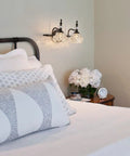 Bedroom with 2 Light Dope Vintage Crystal Vanity Lights Wall Sconces in Black Painted Finish with Thick Crystal Glass Shades.
