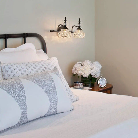 Bedroom with 2 Light Dope Vintage Crystal Vanity Lights Wall Sconces in Black Painted Finish with Thick Crystal Glass Shades.