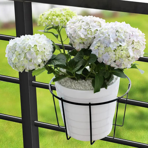 Three Pack 10 Inch Railing Planters For Balcony Or Porch Hanging Baskets Outdoor Indoor Flower Pot Holders Fits Up To Nine And A Half Inch Pots And Two And Three Quarter Inch Rail No Fuss Easy Hang Metal Fence Planters with white flowers.