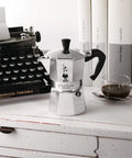 Moka Express Stovetop Espresso Maker For Real Italian Coffee Nine Cup Moka Pot In Aluminum Silver on a countertop