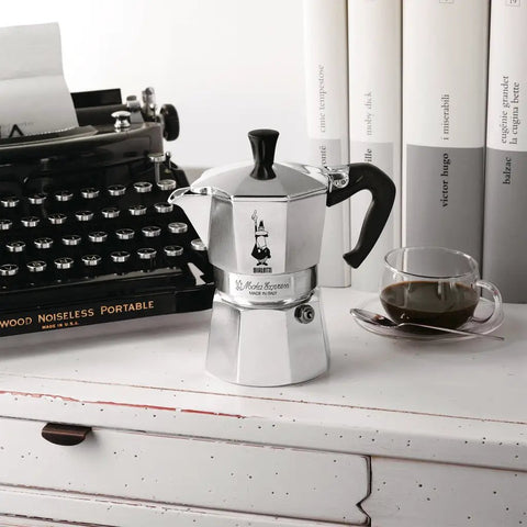 Moka Express Stovetop Espresso Maker For Real Italian Coffee Nine Cup Moka Pot In Aluminum Silver on a countertop
