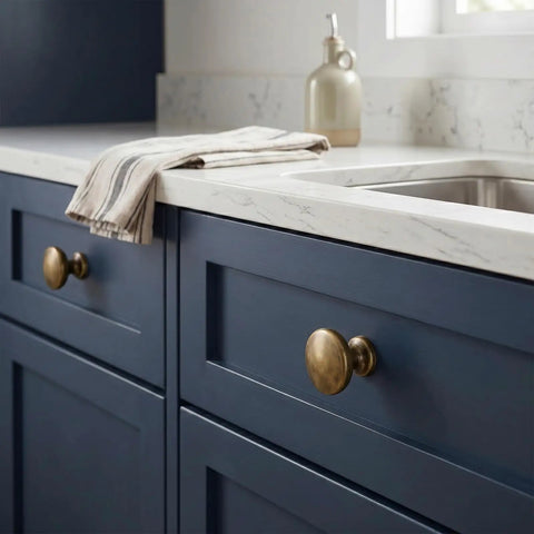 Antique Brass Cabinet Knobs Set of 25 Solid Zinc Alloy Hardware on blue kitchen drawers with marble countertop