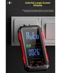 Workhorse Digital Multimeter With USB Rechargeable Auto Ranging shown against a wall socket with colorful large screen display.