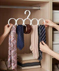 Slick Closet Organizer And Scarf Hanger That Crushes Your Morning Clutter With Wide Loops For Quick Belt Tie And Hijab Storage, displaying ties and scarves on rings.