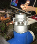 Off Grid 1000W Water Turbine Generator 220V 50Hz Mini Hydro System installed outdoors with running water and lighting setup
