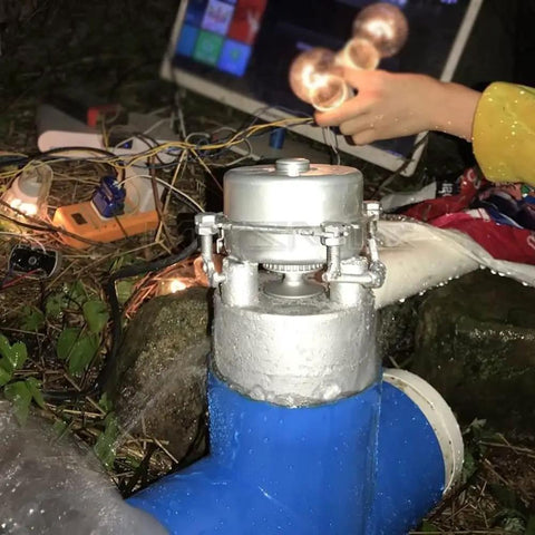 Off Grid 1000W Water Turbine Generator 220V 50Hz Mini Hydro System installed outdoors with running water and lighting setup