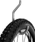 Close-up of a bike tire hung on a 8 Pack Bike Hanger Storage Hooks Heavy Duty Steel Screw In Hooks For Garage Wall And Ceiling Bicycle Storage Utility Tool Hanger Easy Install In Stud Walls Gray.