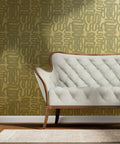 Dope Abstract Graffiti Gold Metallic Wallpaper Fibrous Texture Eco Friendly Type I Class A Fire Rated Made In USA Non Toxic Paste The Wall Premium Indoor Wall Covering on living room wall with white tufted sofa.