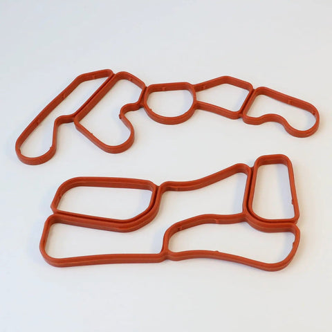 Engine Oil Filter Housing Gasket Set 2721840080 2721840280 for Mercedes M272 Engines, showing two red gasket pieces on white background.