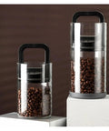Premium Vacuum Sealed Clear Glass Coffee Bean Canister With Secure Airtight Lid, two sizes displayed with coffee beans inside.
