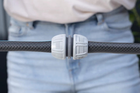 Close-up of Five Eighth Inch Hose End Repair Kit for Garden Hose Fittings with Power Grip connector installed on a hose.