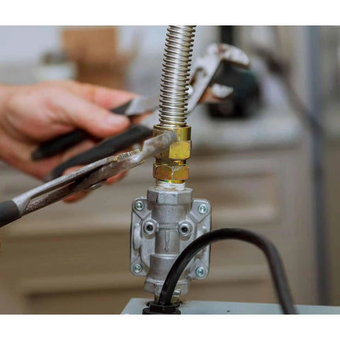 Close-up of a 1/2-in gas pressure regulator with brass fittings on a propane/natural gas line.