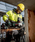 Worker using Pro Grade 18 Volt Cordless Angle Grinder With Brushless Motor And Quick Change Spindle for metal cutting on-site.