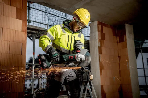 Worker using Pro Grade 18 Volt Cordless Angle Grinder With Brushless Motor And Quick Change Spindle for metal cutting on-site.