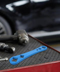 Heavy Duty Oil Drain Screw Removal Tool And 30mm Hexagonal Socket Wrench For Cars on a tool table with other equipment.