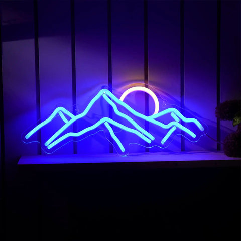 Sunrise Mountain Neon Light Sign USB Powered LED Wall Decor With Moon And Peaks glowing in blue and yellow on a shelf.
