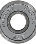 Bones Swiss ceramic skateboard bearing, gray metal with engraved lettering, close-up view