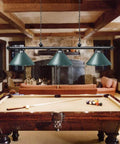 59 Inch Hanging Pool Table Light With Three Shade Billiard Lamps over a billiard table, rustic game room setting, green finish