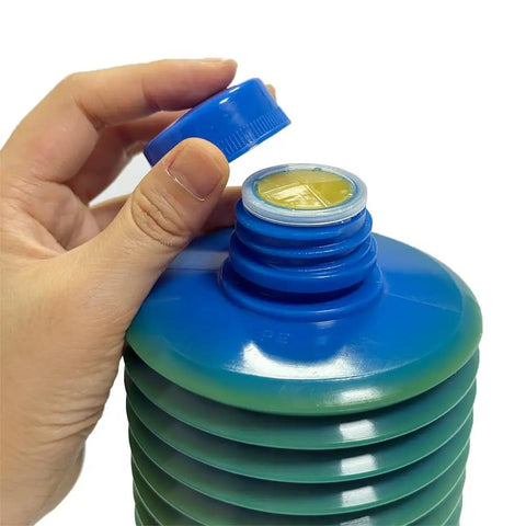 Hand opening 700ml LHL X100 7 CNC Machining Center Heavy Duty Grease container, blue cap detached, yellow lubricant visible