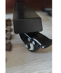 Close-up of Heavy Duty Silent Caster Wheels With Reliable Brakes, featuring a clean black finish and locking lever for furniture.
