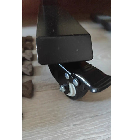 Close-up of Heavy Duty Silent Caster Wheels With Reliable Brakes, featuring a clean black finish and locking lever for furniture.