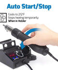 Person holding a compact hot air rework station kit with integrated nozzle holder and digital display, showcasing auto start/stop feature.