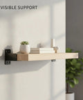 Floating wooden shelf mounted with Hidden Triangle Shelf Brackets 2-Pack, Minimalist Metal Wall Mounts, featuring discreet hardware.