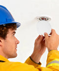 Four Piece Concealed Fire Sprinkler Head Cover Plates White Iron Round Flat Decorative Shield Top Shelf Polish No Sweat Wipe Down Straight Shot Install Pro Grade Safety For House Commercial Spaces being installed by a worker.
