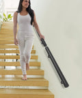 Wall Mounted Stainless Steel Handrail For Indoor Stairs Showing Off A Matte Coat And Tank Grade Build That Takes Scratches Like A Boss While Keeping Your Steps Locked Down Tight with a woman descending stairs.