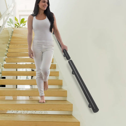 Wall Mounted Stainless Steel Handrail For Indoor Stairs Showing Off A Matte Coat And Tank Grade Build That Takes Scratches Like A Boss While Keeping Your Steps Locked Down Tight with a woman descending stairs.