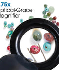 LED Clip On Magnifying Glass With Light For Crafting And Needlework Hands Free Adjustable Arm Desk Lamp Optical Grade Magnification ClearSun LED Technology Perfect Book Light And Reading Lamp showing 1.75x optical-grade magnification on colorful beads