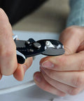 Close-up of hands using Pro Grade All In One Wire Cutters And Stripper For Pros 8 Inch Heavy Duty Cable Cutters on cable