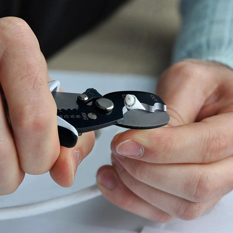 Close-up of hands using Pro Grade All In One Wire Cutters And Stripper For Pros 8 Inch Heavy Duty Cable Cutters on cable