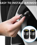 Chevrolet Tire Valve Stem Caps 4 Pack Aluminum Alloy Black Easy Install Auto Wheel Air Caps Corrosion Resistant Durable Metal Valve Caps For Chevy Cars being installed.