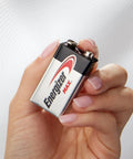 Person holding a 9V battery in hand, focus on Energizer Max branding. Suitable for smoke detectors, toys, and electronics.