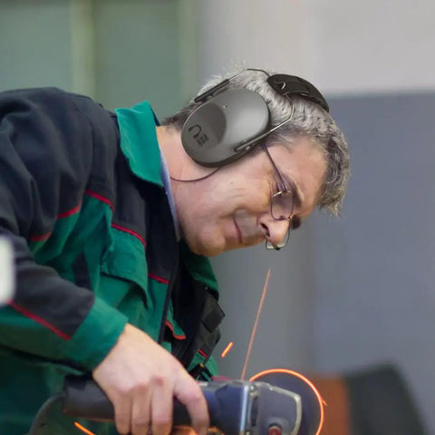 Grey 34 dB NRR Hearing Protection Ear Muffs for Loud Events and Sensory Use worn by worker using power tool