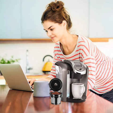 Woman using laptop with Universal Fit Reusable Coffee Filters With Food Grade Stainless Steel Mesh for K Cup Brewers 1.0 and 2.0