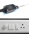 Fast Acting Micro Switch TZ-8166 Momentary Limit Switch for Electrical Control with wall socket in background