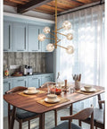 Stunning Six Head Kitchen Pendant Lights Matte Glass Table Chandelier For Dining Room Lighting Easy Install over a wooden table.