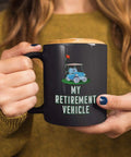 Sweet Retirement Ride Golf Cart Coffee Mug In 15 Oz Black Ceramic With Hella Durable Glaze For Retired Golfers And Youth Coaches Looking To Kick Back With Their Daily Brew held by a person