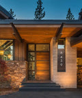 Real Deal Reclaimed Rustic Wood Stain Providing A Hella Smooth Water Based Finish That Reacts Naturally With Tannins To Create An Authentic Weathered Look Perfect For Interior Or Exterior Makeovers In A Convenient 55 Gallon Barrel near the entrance of a modern cabin.