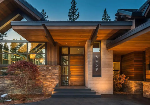 Real Deal Reclaimed Rustic Wood Stain Providing A Hella Smooth Water Based Finish That Reacts Naturally With Tannins To Create An Authentic Weathered Look Perfect For Interior Or Exterior Makeovers In A Convenient 55 Gallon Barrel near the entrance of a modern cabin.